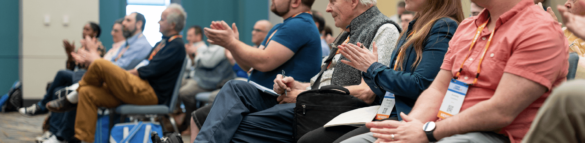 Attendees sitting in breakout session clapping
